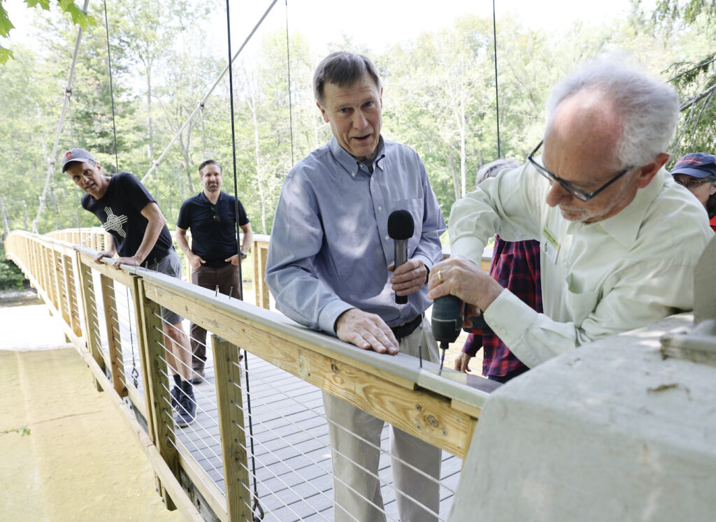 Charlie Trautmann watches the final step in the rebuilding